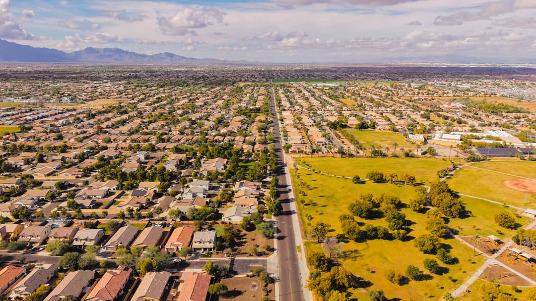 Master-planned neighborhoods stretch across the Valley of the Sun toward the desert mountains.