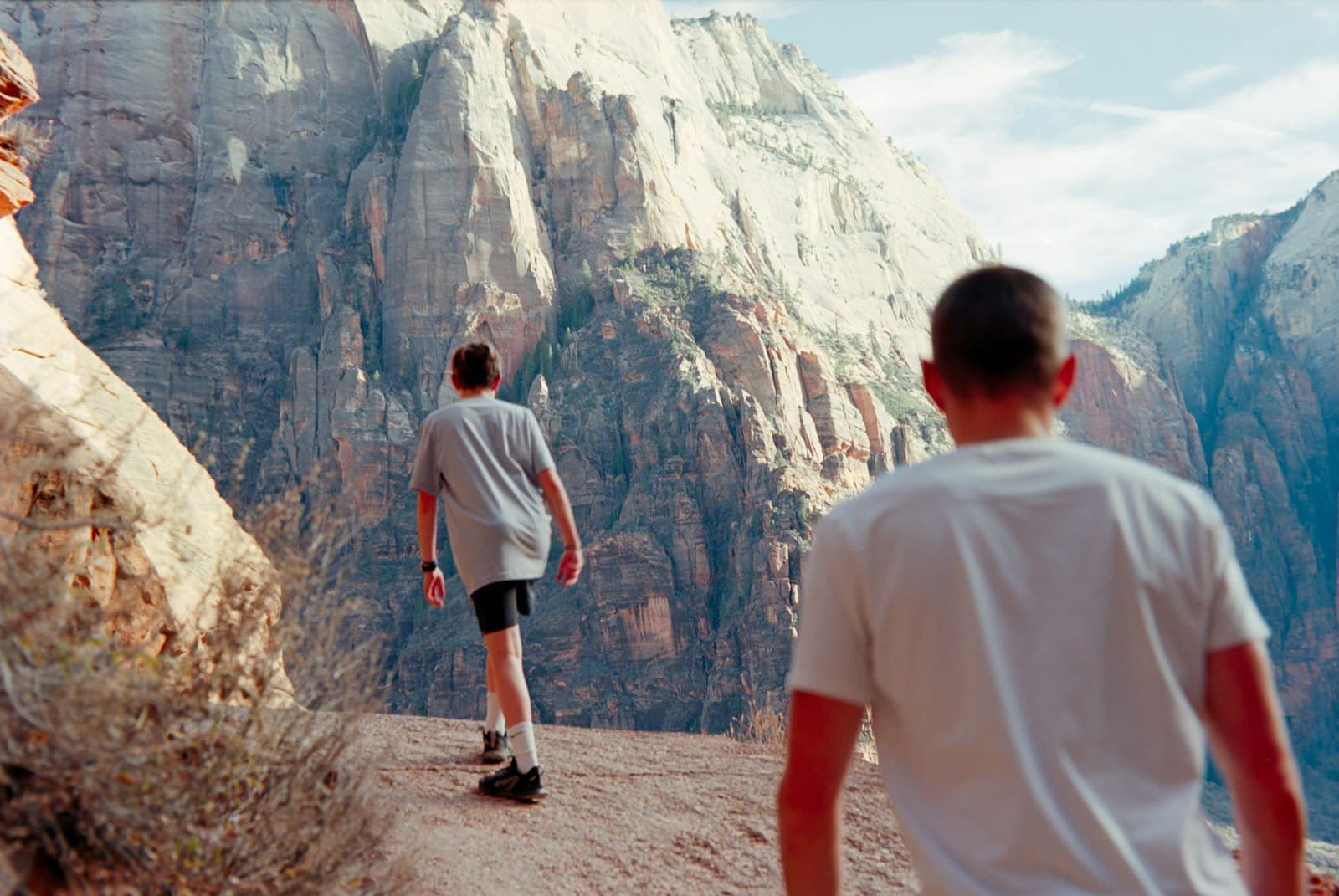 Two hikers on a sunlit canyon trail, peptides for energy at PeRx