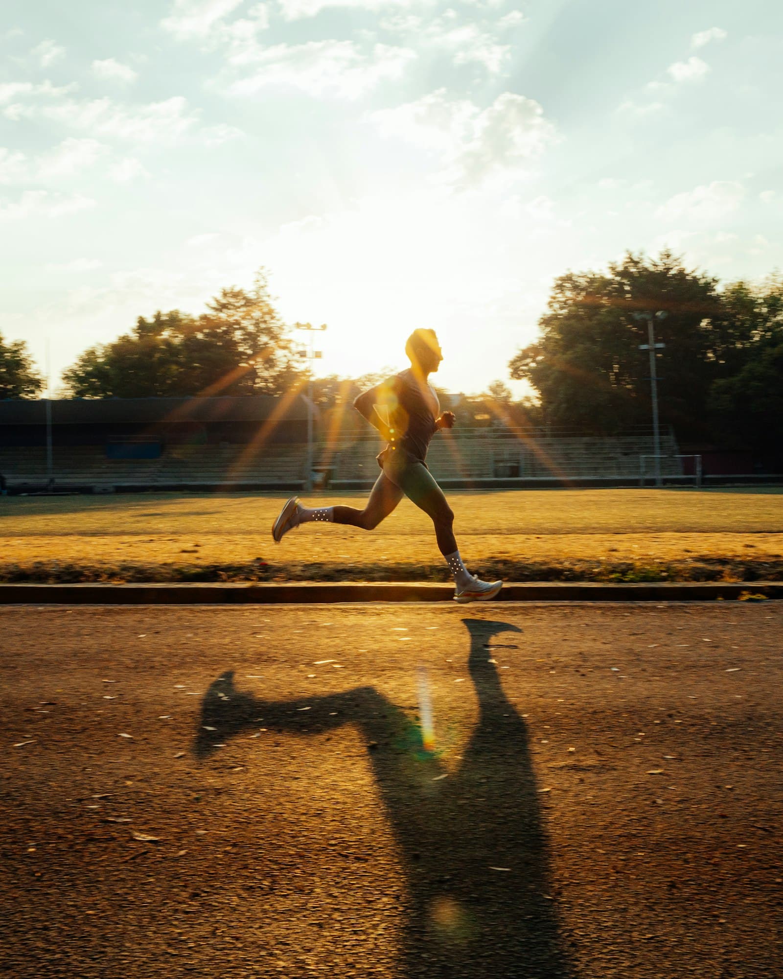 Runner mid-stride on a track at sunrise, growth hormone peptides at PeRx