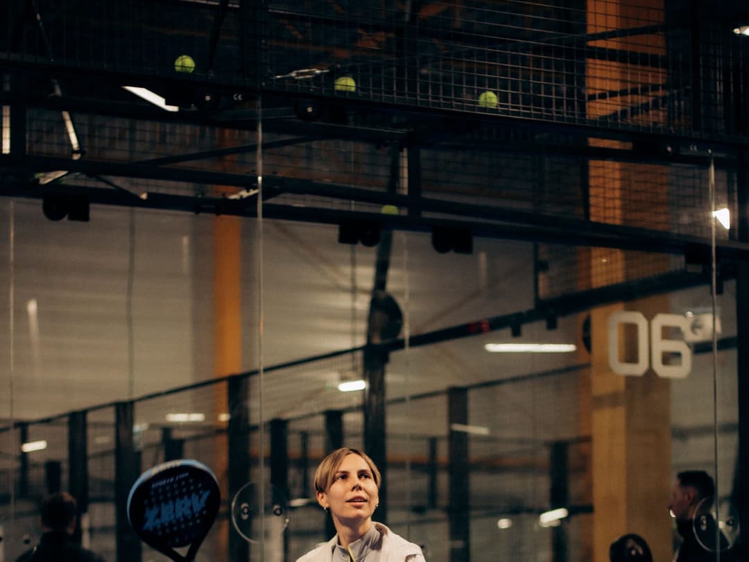 The overhead bandeja off the back glass, where padel loads the shoulder and the elbow pays the price.