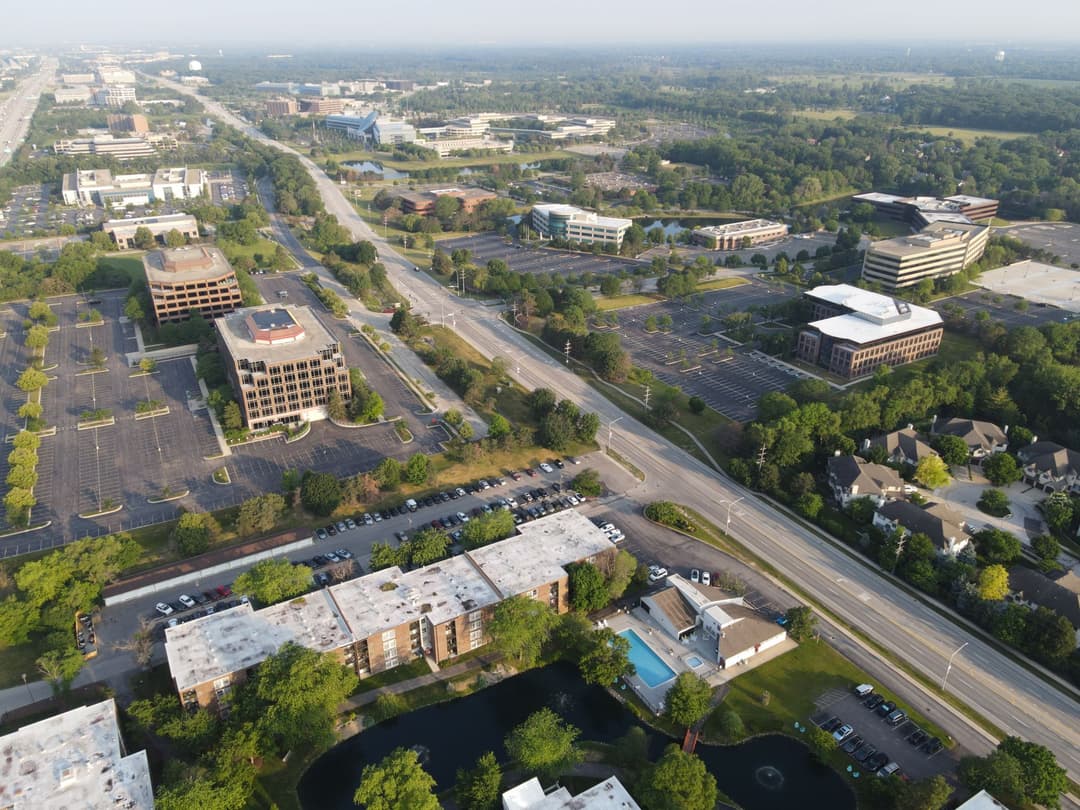 Office towers along a landscaped suburban corporate corridor.