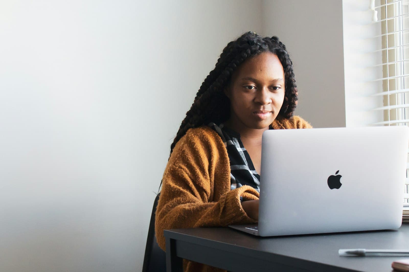 Woman working with deep focus at a bright desk, nootropic peptides at PeRx