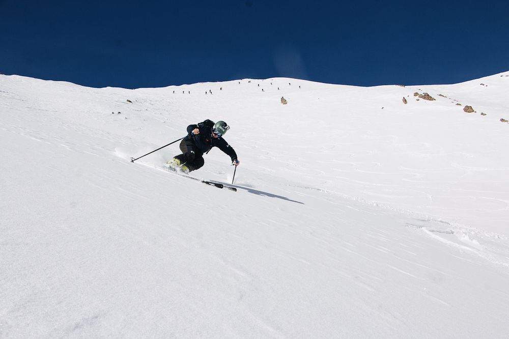 Skier carving down a snow-covered slope